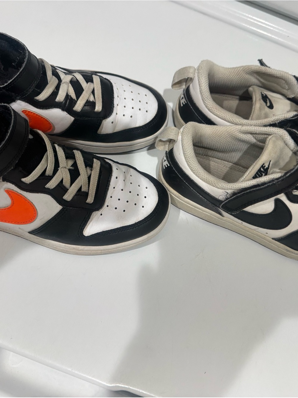 Nike Kids Black and White Sneakers with Orange Swoosh Accent